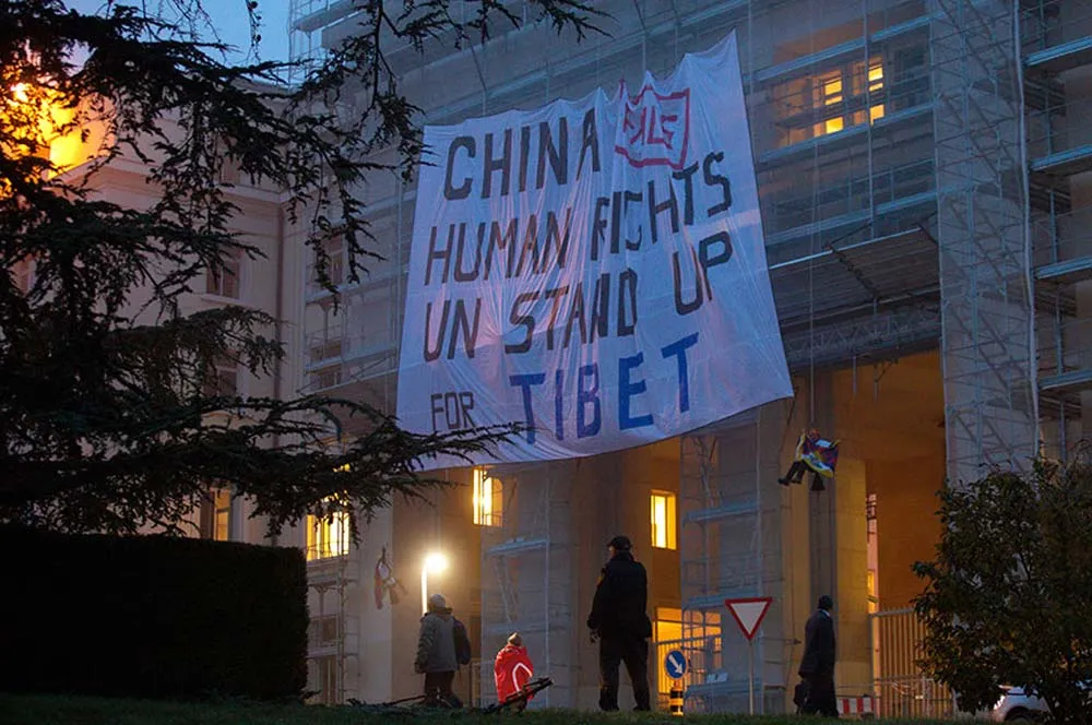 SFT activists display a huge banner on scaffolding in front of the of the United Nations, in Geneva, 2013